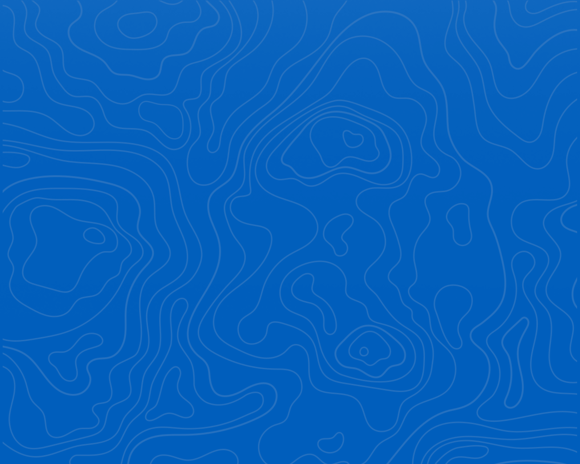 Smiling angler on a rocky shore with a fish and travel fishing rod